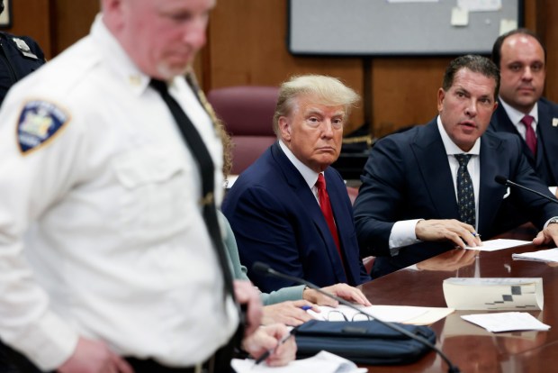 NEW YORK, NY - APRIL 04: Former U.S. President Donald Trump sits in the courtroom with his attorneys Joe Tacopina and Boris Epshteyn (R) during his arraignment at the Manhattan Criminal Court April 4, 2023 in New York City. Trump pleaded not guilty to 34 felony counts stemming from hush money payments made to adult film star Stormy Daniels before the 2016 presidential election and making false statements to cover up other crimes. With his indictment, Trump will become the first former U.S. president in history to be charged with a criminal offense. (Photo by Andrew Kelly-Pool/Getty Images)