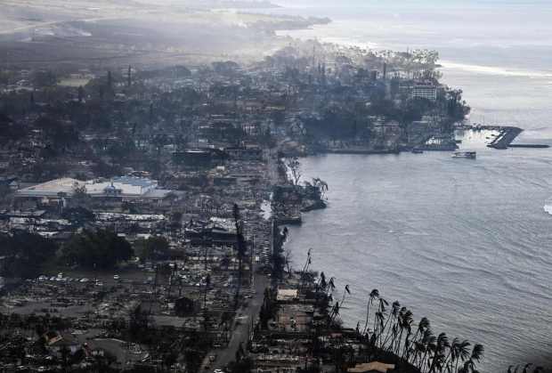 An aerial view shows destroyed homes and buildings that burned to the ground around the harbor and Front Street in the historic Lahaina Town in the aftermath of wildfires in western Maui in Lahaina, Hawaii, on August 10, 2023. At least 36 people have died after a fast-moving wildfire turned Lahaina to ashes, officials said August 9, as visitors asked to leave the island of Maui found themselves stranded at the airport. The fires began burning early August 8, scorching thousands of acres and putting homes, businesses and 35,000 lives at risk on Maui, the Hawaii Emergency Management Agency said in a statement. (Photo by Patrick T. Fallon / AFP) (Photo by PATRICK T. FALLON/AFP via Getty Images)