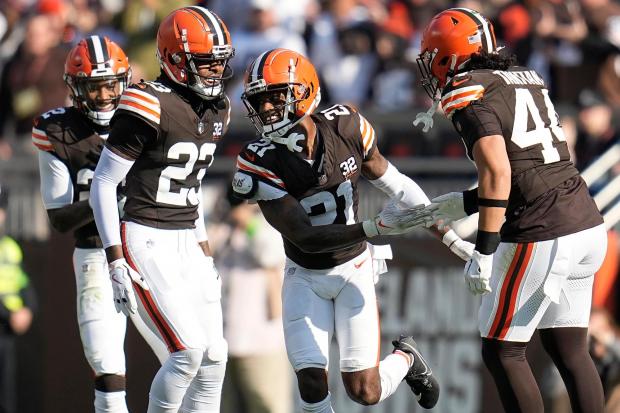 Denzel Ward is congratulated by Grant Delpit, left, Martin Emerson Jr. (23) and Sione Takitaki (44) after intercepting a pass against the Cardinals on Nov. 5. (Sue Ogrocki - The Associated Press)