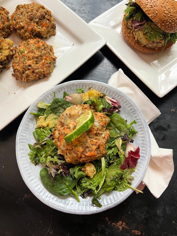 A salmon patty on salad.