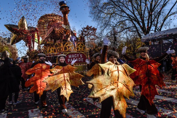 NEW YORK, NEW YORK - NOVEMBER 23: People participate in Macy's annual Thanksgiving Day Parade on November 23, 2023 in New York City. Thousands of people lined the streets to watch the 25 balloons and hundreds of performers march in this parade happening since 1924. (Photo by Stephanie Keith/Getty Images)