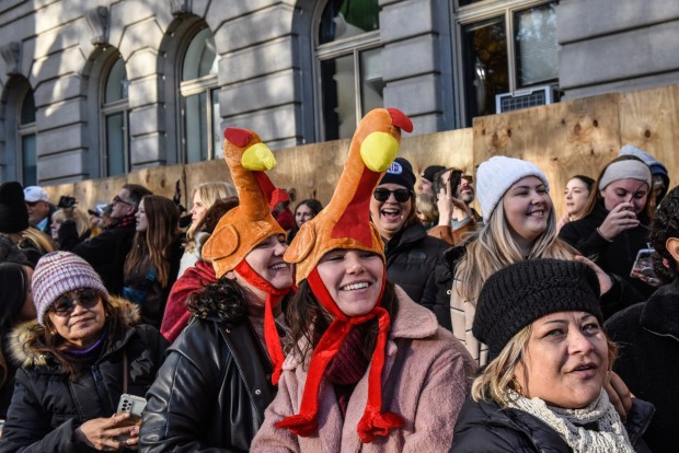 NEW YORK, NEW YORK - NOVEMBER 23: Spectators watch the Macy's annual Thanksgiving Day Parade on November 23, 2023 in New York City. Thousands of people lined the streets to watch the 25 balloons and hundreds of performers march in this parade happening since 1924. (Photo by Stephanie Keith/Getty Images)