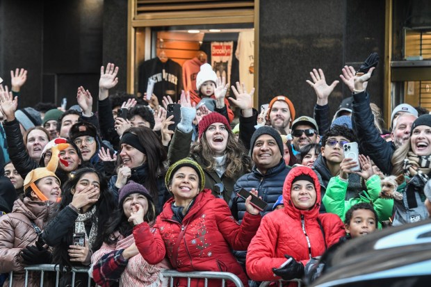 NEW YORK, NEW YORK - NOVEMBER 23: Spectators watch the Macy's annual Thanksgiving Day Parade on November 23, 2023 in New York City. Thousands of people lined the streets to watch the 25 balloons and hundreds of performers march in this parade happening since 1924. (Photo by Stephanie Keith/Getty Images)