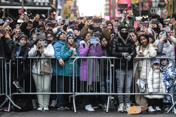 NEW YORK, NEW YORK - NOVEMBER 23: Spectators watch the Macy's annual Thanksgiving Day Parade on November 23, 2023 in New York City. Thousands of people lined the streets to watch the 25 balloons and hundreds of performers march in this parade happening since 1924. (Photo by Stephanie Keith/Getty Images)