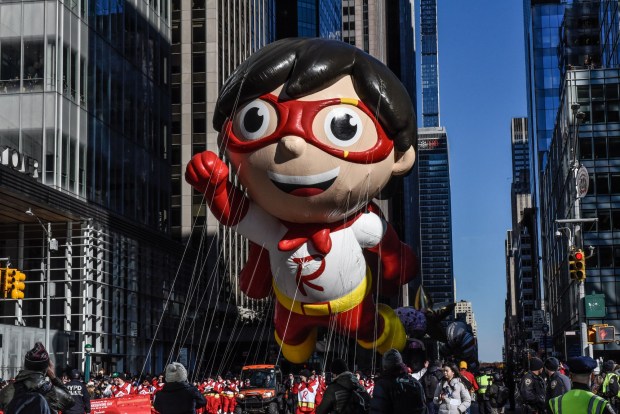 NEW YORK, NEW YORK - NOVEMBER 23: The Red Titan from Ryan's World balloon floats in Macy's annual Thanksgiving Day Parade on November 23, 2023 in New York City. Thousands of people lined the streets to watch the 25 balloons and hundreds of performers march in this parade happening since 1924. (Photo by Stephanie Keith/Getty Images)