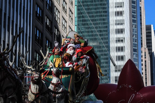 NEW YORK, NEW YORK - NOVEMBER 23: A person depicting Santa Claus participates in Macy's annual Thanksgiving Day Parade on November 23, 2023 in New York City. Thousands of people lined the streets to watch the 25 balloons and hundreds of performers march in this parade happening since 1924. (Photo by Stephanie Keith/Getty Images)