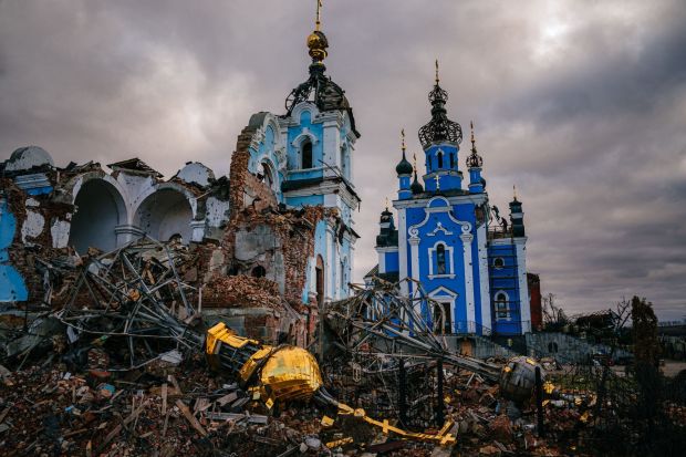 Construction workers climb onto the roof of a destroyed church in the village of Bohorodychne, Donetsk region on January 4, 2023, amid the Russian invasion of Ukraine. - Bohorodychne is a village in Donetsk region that came under heavy attack by Russian forces in June 2022, during the Russian invasion of Ukraine. On August 17, 2022 the Russian forces captured the village. The Armed Forces of Ukraine announced on September 12, 2022 that they took back the control over the village. A few resident came back to restore their destroyed houses and live in the village. (Photo by Dimitar DILKOFF / AFP) (Photo by DIMITAR DILKOFF/AFP via Getty Images)