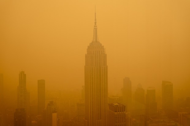 NEW YORK, NEW YORK - JUNE 7: Smoky haze from wildfires in Canada diminishes the visibility of the Empire State Building on June 7, 2023 in New York City. New York topped the list of most polluted major cities in the world on Tuesday night, as smoke from the fires continues to blanket the East Coast. (Photo by David Dee Delgado/Getty Images)