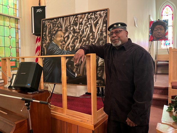 Lorain artist Jeff Pye stands with a piece of his artwork at Wesley United Methodist Church, 220 W 7th St. in Lorain, on Martin Luther King Jr. Day, Jan. 15. (Martin McConnell - The Morning Journal)