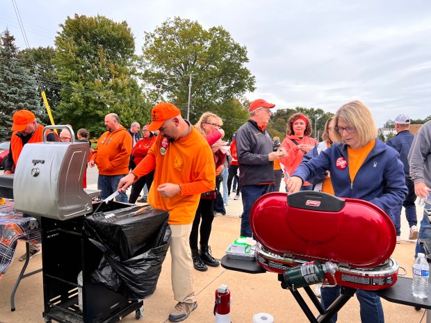 Union members like Nate Wolshuck, left, and Joyce Kasnyik prepared hot dogs for rally goers as they came together for a resolution Oct. 10. (Lauren Hoffman -- The Morning Journal)