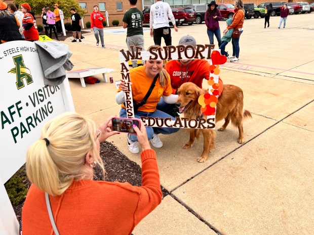 Families showed their support for the teachers by taking photos with a handmade picture frame provided by union member Diana Beetler. (Lauren Hoffman -- The Morning Journal)