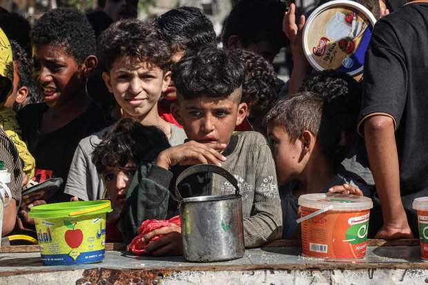 Palestinian children queue to receive a portion of food at a make-shift charity kitchen in Rafah in the southern Gaza Strip, on November 8, 2023, amid the ongoing battles between Israel and the militant group Hamas. (Photo by SAID KHATIB / AFP) (Photo by SAID KHATIB/AFP via Getty Images)