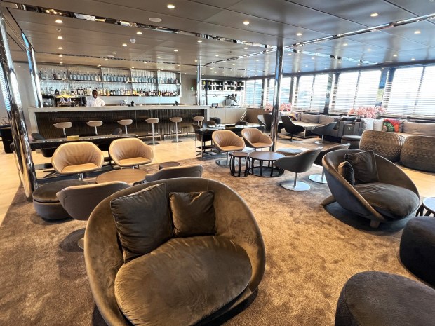 The Amici Lounge and adjoining bar is a comfy social setting aboard the Emerald Azzurra. (Photo by David Dickstein)