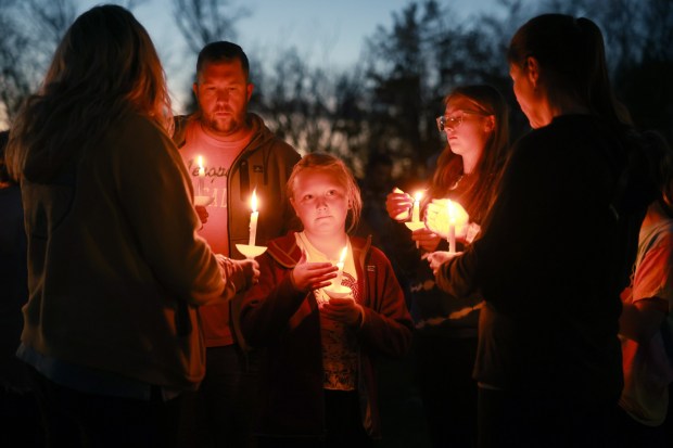 LISBON, MAINE - OCTOBER 28: (L-R) Adam Jones, Sadie Huntley, and Skylar Meserve during a candlelight vigil to honor the victims of the Lewiston shootings on October 28, 2023 in Lisbon, Maine. Card killed 18 people in a mass shooting at a bowling alley and a restaurant in Lewiston and was found dead in Lisbon. (Photo by Joe Raedle/Getty Images)