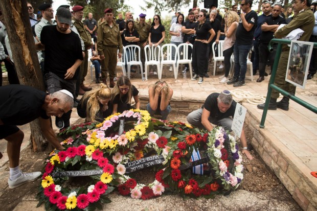 KFAR MENACHEM, ISRAEL - OCTOBER 09: Family and friends of fallen IDF soldier Afik Rozental, who died in a battle with Hamas militants, attend his funeral on October 9, 2023 in Kfar Menachem, Israel. On October 7, the Palestinian militant group Hamas launched a surprise attack on Israel from Gaza by land, sea, and air, killing over 700 people and wounding more than 2000. Israeli soldiers and civilians have also been kidnapped by Hamas and taken into Gaza. The attack prompted a declaration of war by Israeli Prime Minister Benjamin Netanyahu, and ongoing retaliatory strikes by Israel on Gaza killing hundreds. (Photo by Amir Levy/Getty Images)