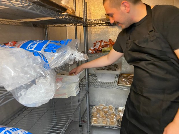 Jeff Morsfield Owner of Jeff's Candy Shop shows his depleted butter stock which he uses for his candy business. (Frank Mecham- The News-Herald.)