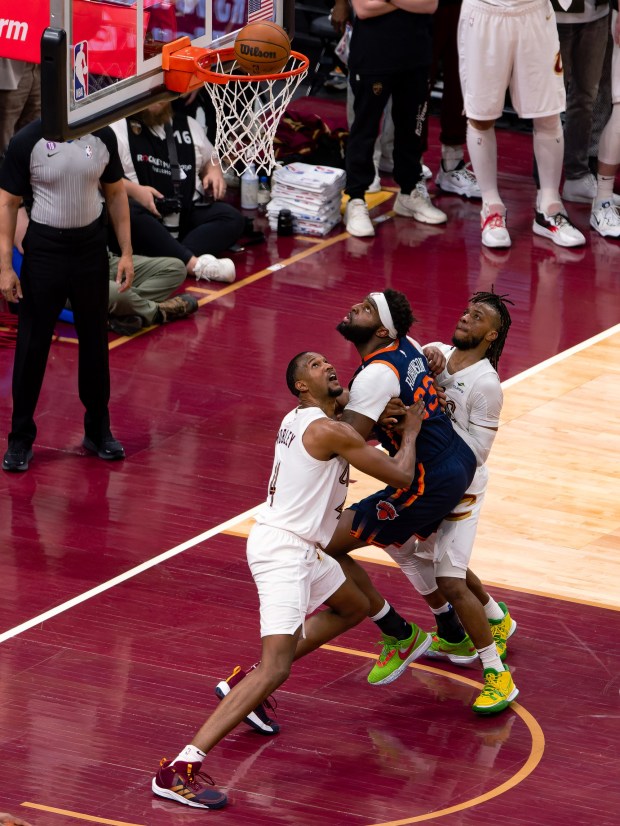 Evan Mobley and Darius Garland and the Knicks' Mitchell Robinson watch a shot during the Cavaliers' loss to the Knicks on April 15. (Brian Fisher - For The News Herald)