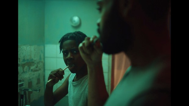 Benji, portrayed by Jedaiah Bannerman, left, finds a father figure in Izi, played by Kane Robinson, in "The Kitchen." (Courtesy of Netflix)