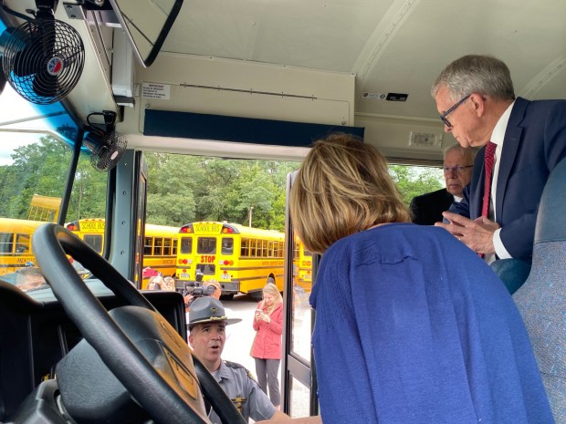 Lt. Aaron Reimer, of the Ohio State Highway Patrol, gives more information to Gov. Mike DeWine on how school bus inspections are carried out. (Frank Mecham- The News-Herald.)