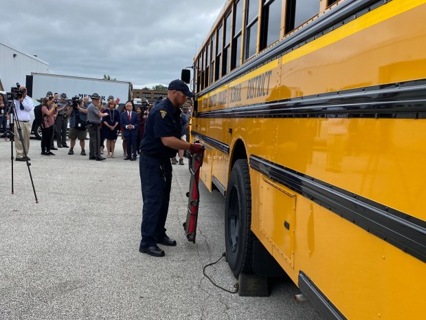 An inspector with the Ohio Highway Patrol demonstrates an inspection of one of Mentor School Districts buses. (Frank Mecham- The News-Herald.)