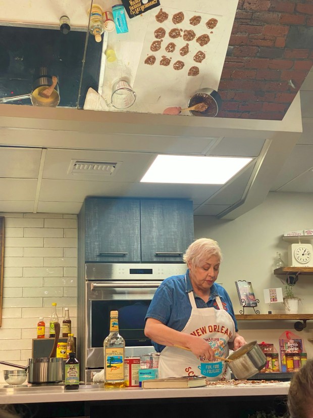 Foolproof pralines, a sweet Creole confection, are scooped onto parchment paper by chef Cindy Miller for a class at the New Orleans School of Cooking. The size of each scoop determines how many of the pecan candies the recipe makes. (Janet Podolak - The News-Herald)